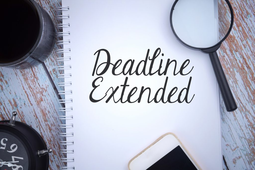 Deadline Extended Image - Wording on pad with cup, phone, magnifying glass